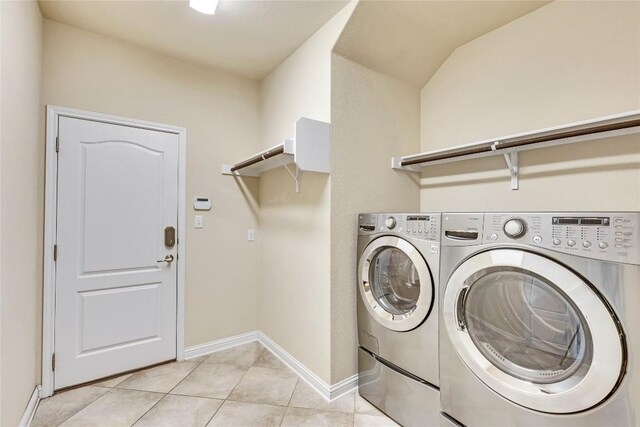 4829 Pyrenees Pass, Austin, TX 78738 - laundry area with washing machine and dryer and light tile patterned floors