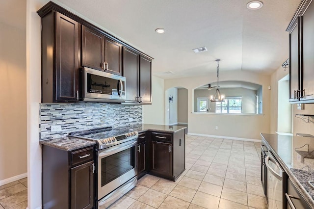 kitchen with backsplash, an inviting chandelier, dark stone counters, and stainless steel appliances
