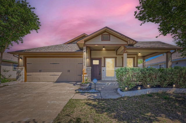 view of front of property with an attached garage and concrete driveway