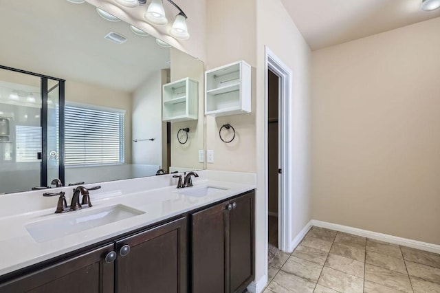 bathroom with baseboards, a sink, and a stall shower
