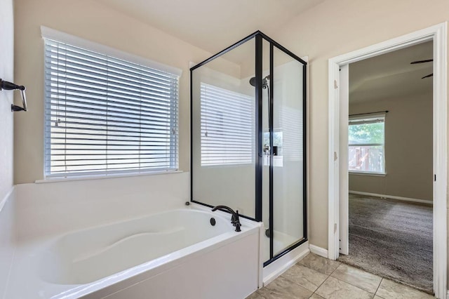 bathroom featuring a shower stall, tile patterned flooring, and a garden tub