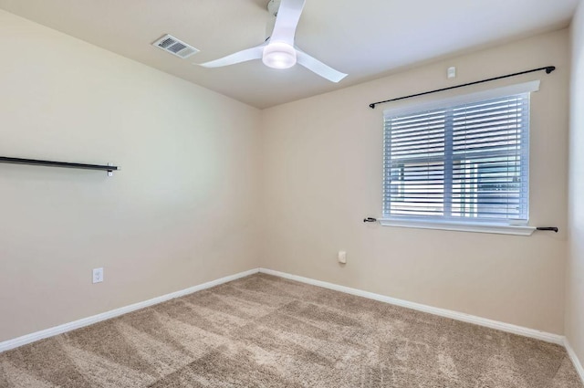 spare room featuring visible vents, baseboards, a ceiling fan, and carpet flooring