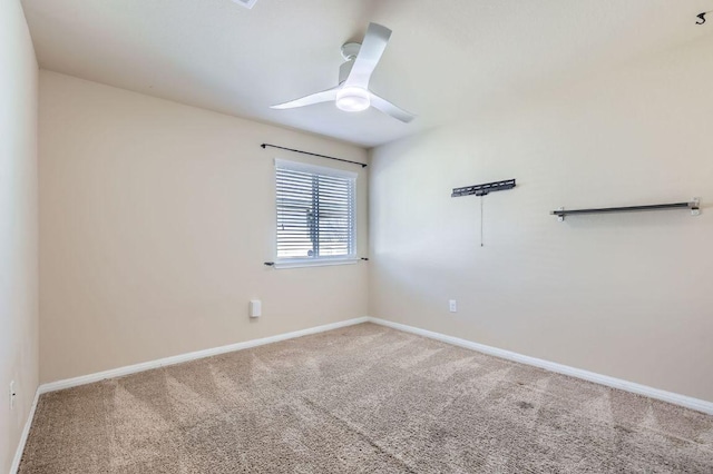 spare room featuring carpet, baseboards, and ceiling fan