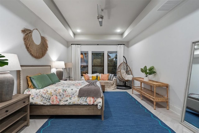bedroom with a ceiling fan, a tray ceiling, recessed lighting, and visible vents