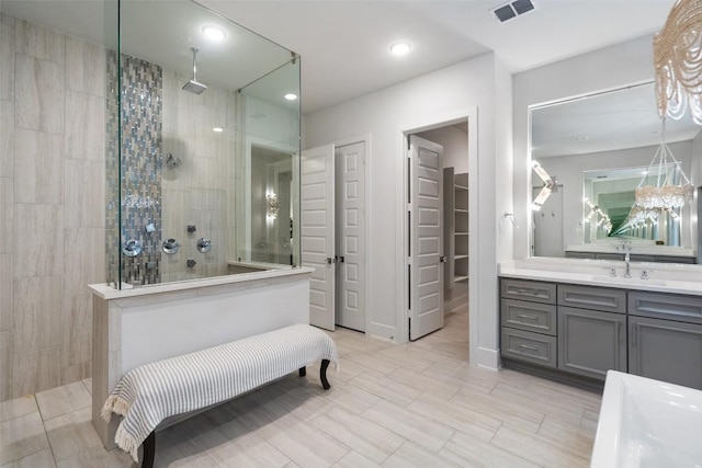 full bathroom with walk in shower, vanity, recessed lighting, visible vents, and a closet