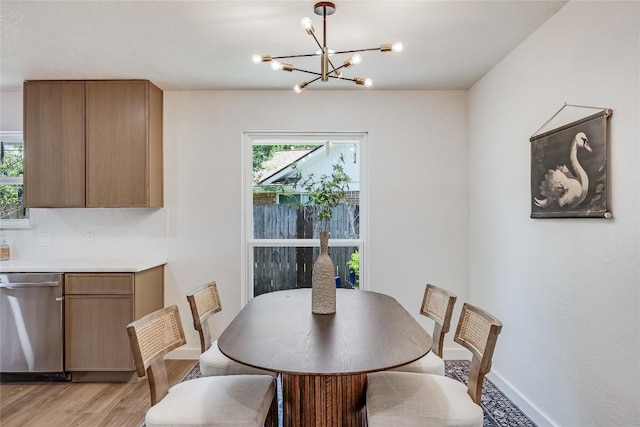 12305 Rustic Manor Ct, Austin, TX 78750 - dining area featuring a chandelier, plenty of natural light, and light wood finished floors