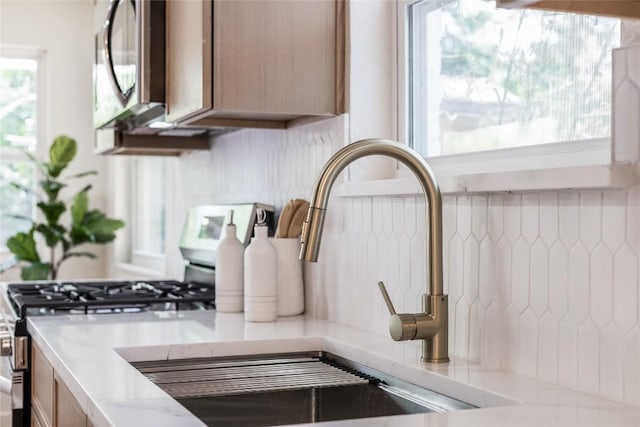 12305 Rustic Manor Ct, Austin, TX 78750 - kitchen view of stainless steel gas range and a sink