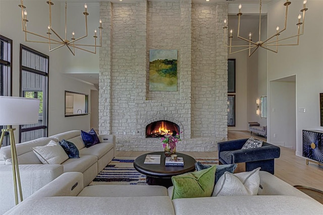 3502 Native Dancer Cv, Austin, TX 78746 - living area featuring a chandelier, a high ceiling, wood finished floors, and a fireplace