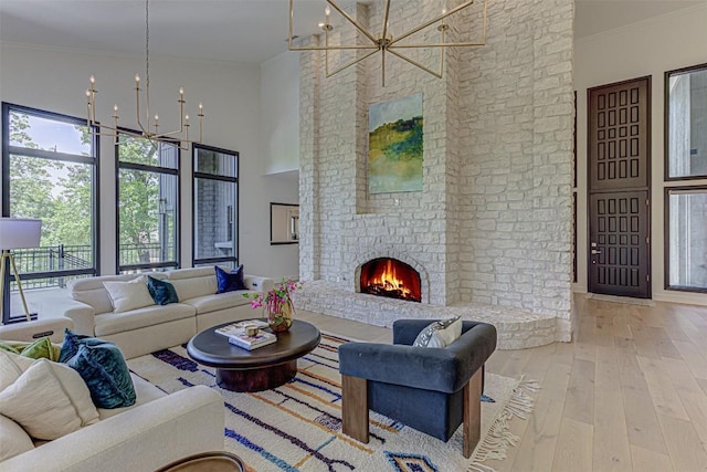 3502 Native Dancer Cv, Austin, TX 78746 - living area with a chandelier, ornamental molding, hardwood / wood-style floors, a fireplace, and a high ceiling