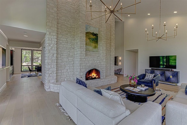 3502 Native Dancer Cv, Austin, TX 78746 - living area with a chandelier, a high ceiling, crown molding, a fireplace, and wood finished floors