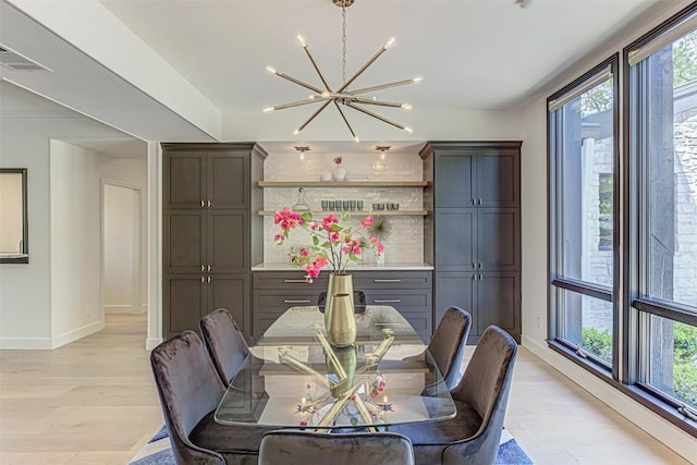 3502 Native Dancer Cv, Austin, TX 78746 - dining room featuring a chandelier, baseboards, and light wood finished floors