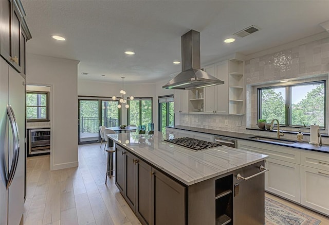 3502 Native Dancer Cv, Austin, TX 78746 - kitchen with open shelves, island exhaust hood, a sink, plenty of natural light, and recessed lighting