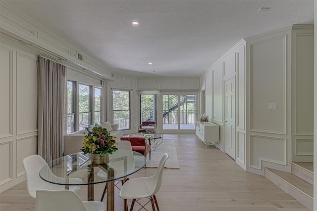 3502 Native Dancer Cv, Austin, TX 78746 - dining space featuring a decorative wall, plenty of natural light, light wood finished floors, a textured ceiling, and recessed lighting