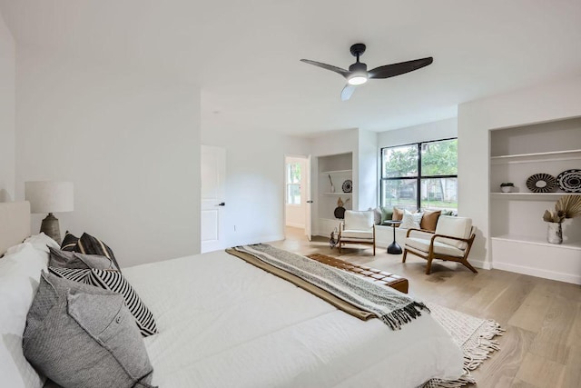 bedroom featuring baseboards, a ceiling fan, and wood finished floors