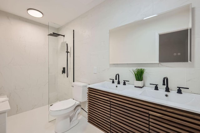 bathroom featuring toilet, walk in shower, a sink, and tile walls