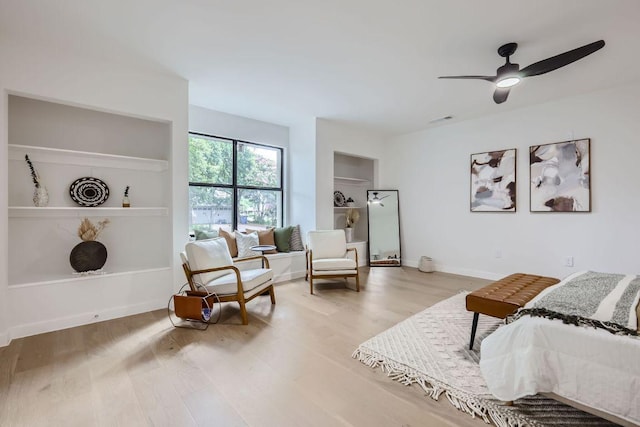 bedroom featuring wood finished floors, ceiling fan, baseboards, and visible vents