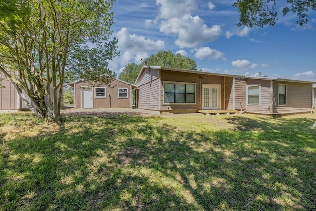 1229 State Highway 304, Gonzales, TX 78629 - rear view of house with french doors, a yard, and an outdoor structure