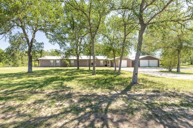1229 State Highway 304, Gonzales, TX 78629 - view of front of home with a detached garage, a front lawn, and an outdoor structure