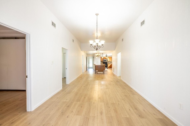 1229 State Highway 304, Gonzales, TX 78629 - hallway with a chandelier and light wood-type flooring
