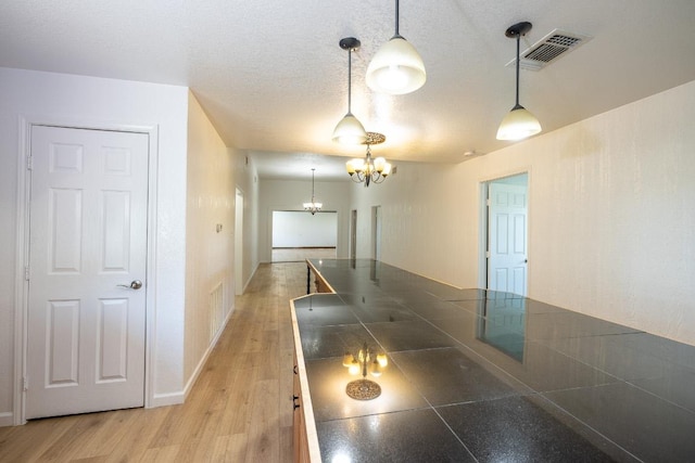 1229 State Highway 304, Gonzales, TX 78629 - spare room with a chandelier and light wood-style floors