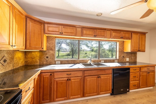1229 State Highway 304, Gonzales, TX 78629 - kitchen featuring black appliances, brown cabinetry, tasteful backsplash, and healthy amount of natural light
