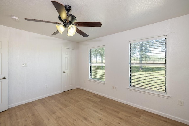 1229 State Highway 304, Gonzales, TX 78629 - spare room with light wood-type flooring, ceiling fan, and a smoke detector