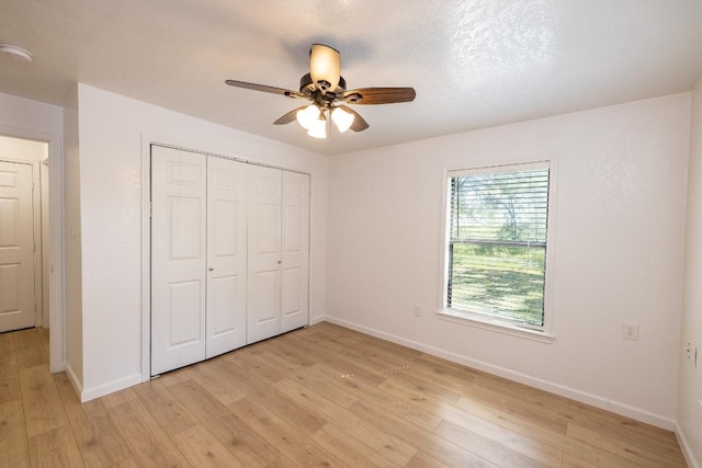 1229 State Highway 304, Gonzales, TX 78629 - unfurnished bedroom with light wood-type flooring, a closet, and ceiling fan
