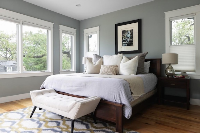 606 E 42nd St, Austin, TX 78751 - bedroom with wood finished floors, multiple windows, and baseboards