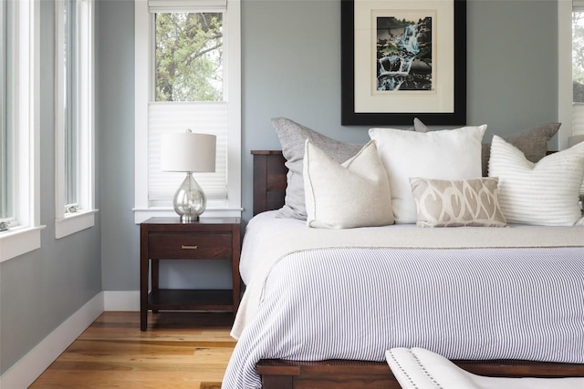 606 E 42nd St, Austin, TX 78751 - bedroom featuring wood finished floors and baseboards