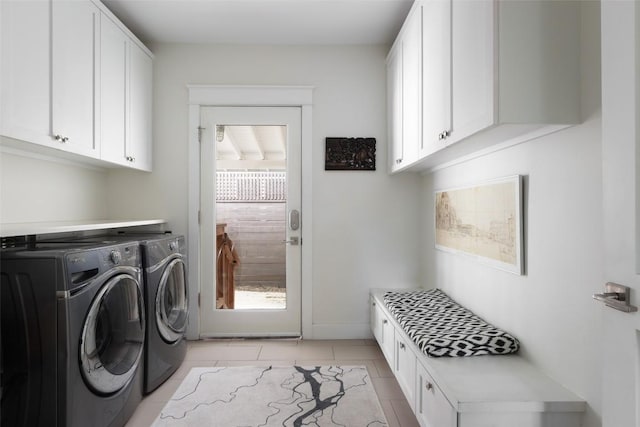 606 E 42nd St, Austin, TX 78751 - laundry room with washing machine and clothes dryer, cabinet space, and light tile patterned flooring