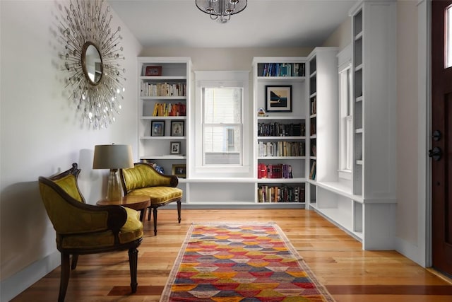 606 E 42nd St, Austin, TX 78751 - sitting room with wood finished floors and a chandelier