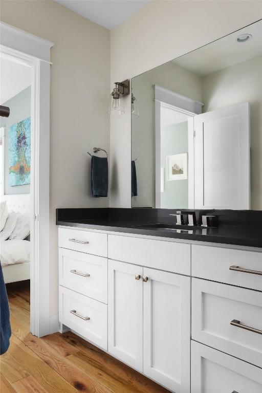 606 E 42nd St, Austin, TX 78751 - ensuite bathroom featuring vanity and wood finished floors