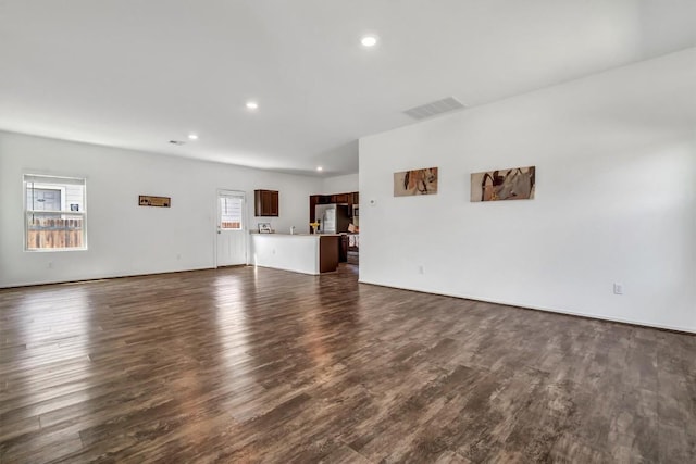 771 Circle Way, Jarrell, TX 76537 - unfurnished living room featuring dark wood-style floors and recessed lighting