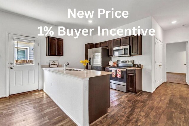 771 Circle Way, Jarrell, TX 76537 - kitchen with stainless steel appliances, dark wood-style floors, dark brown cabinetry, light countertops, and a peninsula