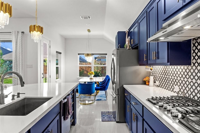 kitchen featuring a sink, appliances with stainless steel finishes, an inviting chandelier, and under cabinet range hood