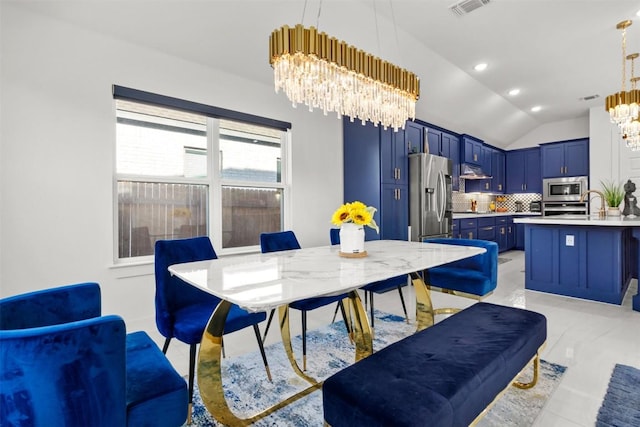dining space featuring a chandelier, vaulted ceiling, and recessed lighting