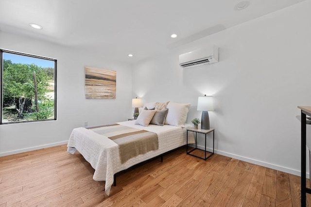 2311 Montclaire St Unit 2, Austin, TX 78704 - bedroom with an AC wall unit, light wood finished floors, and recessed lighting