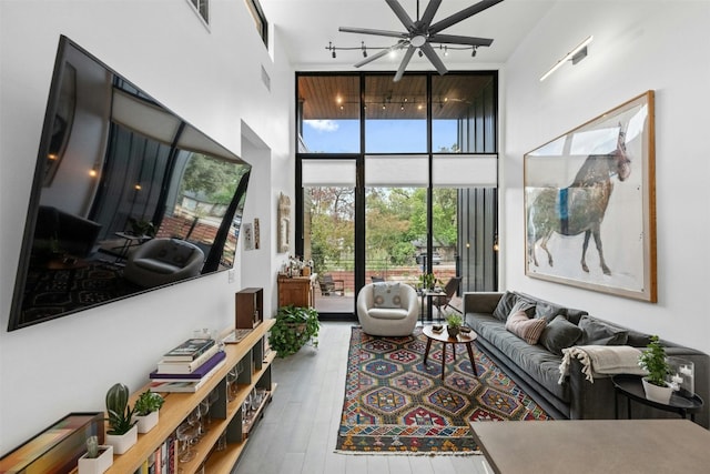 2311 Montclaire St Unit 2, Austin, TX 78704 - living room featuring a high ceiling, ceiling fan, floor to ceiling windows, and hardwood / wood-style flooring