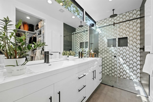 2311 Montclaire St Unit 2, Austin, TX 78704 - bathroom with double vanity, a stall shower, recessed lighting, tile patterned flooring, and tile walls