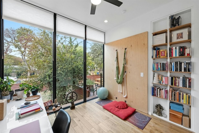 2311 Montclaire St Unit 2, Austin, TX 78704 - home office featuring a wall of windows, a ceiling fan, and wood finished floors