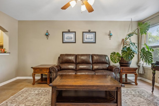 6220 Seville Dr, Austin, TX 78724 - living room with light tile patterned floors, baseboards, and a ceiling fan