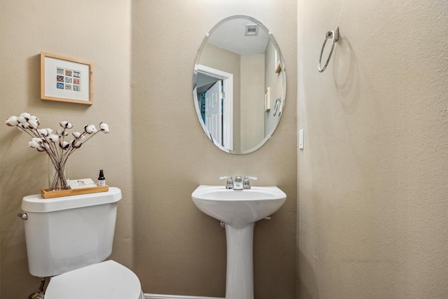 6220 Seville Dr, Austin, TX 78724 - bathroom with visible vents, toilet, and a sink