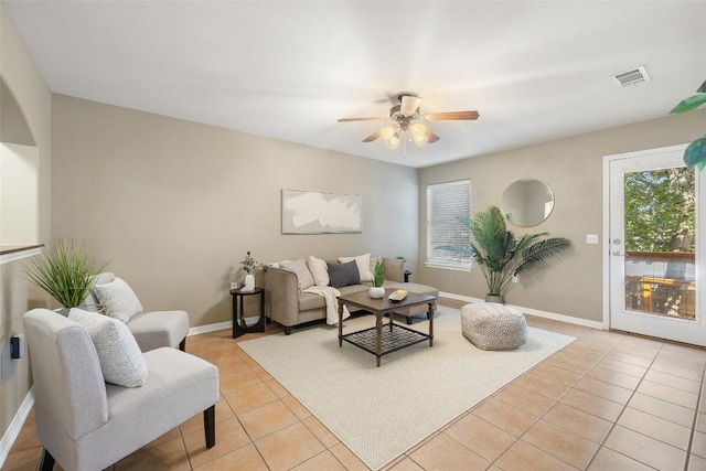 6220 Seville Dr, Austin, TX 78724 - living area featuring light tile patterned flooring, ceiling fan, and baseboards