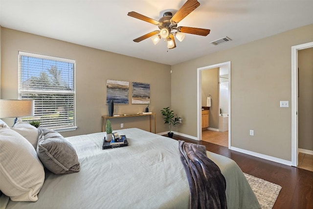 6220 Seville Dr, Austin, TX 78724 - bedroom with wood finished floors, ensuite bathroom, and a ceiling fan