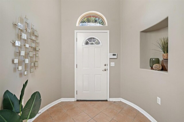 6220 Seville Dr, Austin, TX 78724 - entryway with light tile patterned floors and baseboards