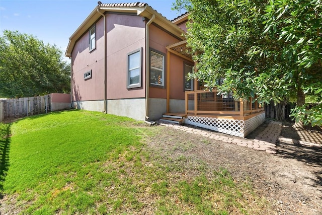 6220 Seville Dr, Austin, TX 78724 - view of property exterior with a wooden deck, a fenced backyard, and stucco siding