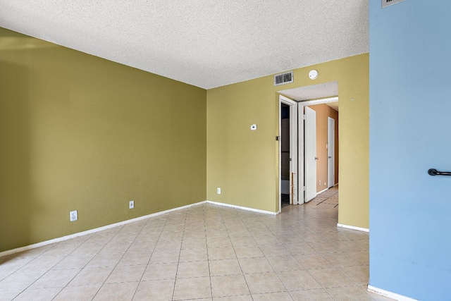 500 E Riverside Dr Unit 146, Austin, TX 78704 - empty room with a textured ceiling, light tile patterned floors, and a smoke detector