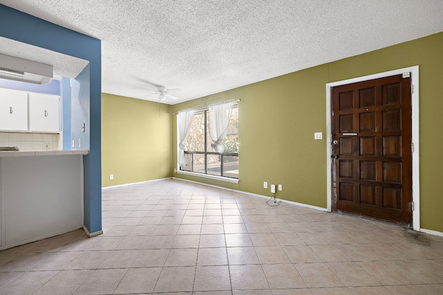 500 E Riverside Dr Unit 146, Austin, TX 78704 - unfurnished living room featuring a textured ceiling, ceiling fan, and light tile patterned floors