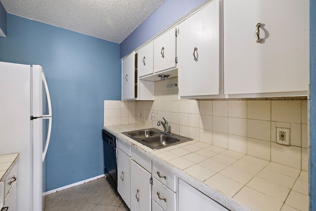 500 E Riverside Dr Unit 146, Austin, TX 78704 - kitchen with freestanding refrigerator, tile counters, white cabinetry, dishwasher, and decorative backsplash
