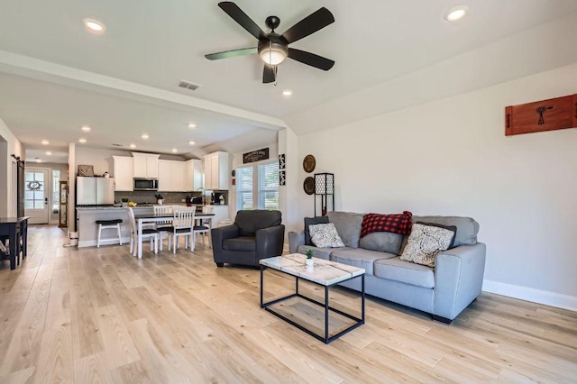 116 Angel Oak Way, San Marcos, TX 78666 - living room with visible vents, light wood-type flooring, and a healthy amount of sunlight